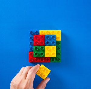 hand stacking up plastic block